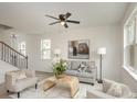 Bright living room with stylish decor, hardwood floors, and a staircase at 927 Cathey Rd, Charlotte, NC 28214