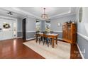 Dining room featuring hardwood floors, a rustic table, and elegant chandelier at 1137 Mckee Farm Ln, Belmont, NC 28012