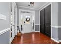 Bright foyer with hardwood floors, white trim, black closet doors, and ample natural light at 1137 Mckee Farm Ln, Belmont, NC 28012