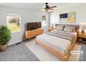 Virtually staged main bedroom with a neutral color scheme and large windows at 153 Pattys Pl, Stony Point, NC 28678