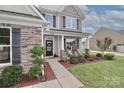 Inviting front porch with stylish decor, perfect for enjoying the outdoors in comfort at 159 W Warfield Dr, Mooresville, NC 28115