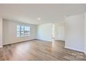 Bright and airy living room with hardwood floors and large window at 1713 Wooten Way, Bessemer City, NC 28016