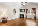 Inviting living room featuring a fireplace, hardwood floors, and a ceiling fan at 2008 Surefire Ct, Denver, NC 28037