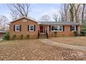 Traditional brick home with black shutters, walkway, and a vibrant red front door at 2044 Birchcrest Dr, Charlotte, NC 28205