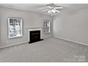 Living room with fireplace and neutral gray carpeting at 2507 Oakdale Creek Ln, Charlotte, NC 28216