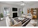 Virtually staged living room featuring a fireplace and comfortable seating at 2507 Oakdale Creek Ln, Charlotte, NC 28216