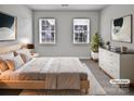 Virtually staged main bedroom with a light and airy feel, featuring a light wood bed frame at 2507 Oakdale Creek Ln, Charlotte, NC 28216