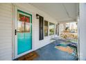 Inviting porch area with cozy seating and a bright colored front door at 30 Hunter St, York, SC 29745
