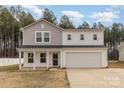 Charming two-story home with a covered porch and attached two car garage at 310 Black Rock School Rd, Cherryville, NC 28021