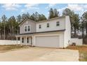 Charming two-story home with a covered porch, attached two car garage, and fenced-in yard at 310 Black Rock School Rd, Cherryville, NC 28021
