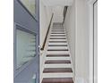 Entryway staircase with dark wood treads, white risers, and a wood handrail at 3617 Vallette Ct, Charlotte, NC 28203