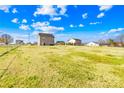 View of a large, grassy backyard, bordered by trees and other houses at 425 Webb Rd, Shelby, NC 28152