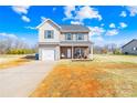 Inviting two-story home with vinyl siding, brick porch, attached garage and a well-maintained front yard at 425 Webb Rd, Shelby, NC 28152