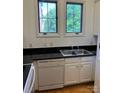 Kitchen features a stainless steel sink, white appliances and cabinets, and granite countertops at 765 N Alexander St, Charlotte, NC 28202