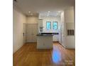 Open-concept living room with hardwood floors, recessed lighting, and access to the kitchen at 765 N Alexander St, Charlotte, NC 28202