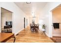 Hallway with gleaming hardwood floors leading to a dining area and other rooms at 909 1St S Ave, Conover, NC 28613