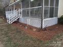 Exterior shot showcasing the home's foundation, complemented by tasteful mulching and landscaping at 92 Foot Hill Dr, Taylorsville, NC 28681