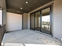 Covered back patio with sliding glass doors and concrete flooring at 95 Seven Oaks Lndg, Belmont, NC 28012