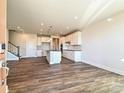 Open concept kitchen with island, hardwood floors, and white cabinets at 95 Seven Oaks Lndg, Belmont, NC 28012
