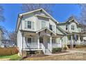 Charming two-story home with a welcoming front porch and well-maintained landscaping at 1211 Pinecrest Ave, Charlotte, NC 28205
