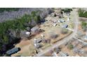 Aerial view of a property featuring mature trees, buildings, and surrounding landscape at 1354 Mirror Lake Rd, Lincolnton, NC 28092