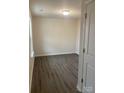 Simple bedroom with grey wood-look flooring and neutral walls at 1606 Lincoln Dr, Shelby, NC 28152
