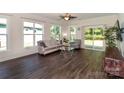 Bright living area featuring wood floors, a ceiling fan, and access to back yard at 184 Flat Rock Dr, Denver, NC 28037