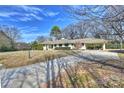 Traditional home boasting a long private driveway and a convenient covered carport at 2100 Sunderland Pl, Charlotte, NC 28211