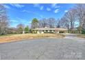 A nice one story house with a circular driveway and a covered carport at 2100 Sunderland Pl, Charlotte, NC 28211