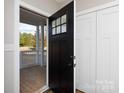 Welcoming entryway featuring a black front door and white closet, offering a glimpse of the outdoors at 2364 Valley Meadows Dr, York, SC 29745