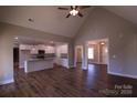 Open concept living area showcases vaulted ceiling, wood floors, and seamless flow into a modern kitchen at 2364 Valley Meadows Dr, York, SC 29745