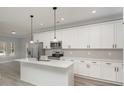 Modern kitchen with stainless steel appliances, a center island with seating, and white cabinets with sleek black hardware at 2365 Kool Park Ne Rd, Hickory, NC 28601