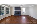 Living room with hardwood floors, fireplace, and bay window at 2650 Whisper Ridge Ln, Matthews, NC 28105