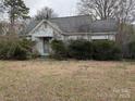 Features a weathered, one-story house with overgrown landscaping and peeling paint at 2801 Pennsylvania Ave, Kannapolis, NC 28083