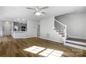 Light-filled living room with hardwood floors and staircase at 3026 Windsor Chase Dr, Matthews, NC 28105