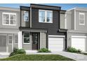 Modern two-story townhome with gray siding and two-car garage at 4114 Lattistep Ln, Charlotte, NC 28269
