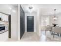 Modern entryway with stone accent wall, and gray door, illuminated by a pendant light at 4125 Rivendell Ln, Mint Hill, NC 28227