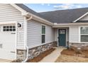 Inviting home exterior with a two-car garage, stone accents, and well-maintained landscaping at 4209 Jones Creek Ln, Charlotte, NC 28215