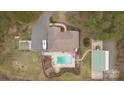 Detailed aerial shot of a property featuring a pool, RV parking, outbuildings, and meticulous landscaping at 47997 Wagoner Rd, Richfield, NC 28137