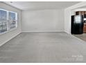 Bright living room with neutral walls and gray carpeting at 6324 Cutwater Cir, Charlotte, NC 28269