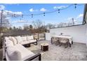 Relaxing rooftop deck with outdoor seating, string lights and neighborhood views at 7020 Loso Commons Way, Charlotte, NC 28217