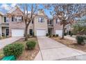 Charming townhome featuring a one-car garage, driveway, and well-maintained landscaping at 7719 Abigail Glen Dr, Charlotte, NC 28212