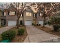 Charming townhome featuring a one-car garage, driveway, and well-maintained landscaping at 7719 Abigail Glen Dr, Charlotte, NC 28212