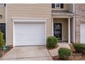 Close-up of the townhome's one-car garage and front entry at 7719 Abigail Glen Dr, Charlotte, NC 28212