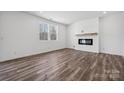 Bright living room featuring hardwood floors and a modern fireplace at 821 Hallman Branch Ln, Lincolnton, NC 28092