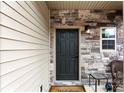 Close-up of a stylish front door with stone accents and a 'Welcome' mat, inviting guests inside at 912 Harbor Islands Ct, Gastonia, NC 28056