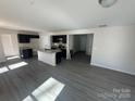 Open concept kitchen with an island and grey laminate flooring at 917 W Sumter St, Shelby, NC 28150
