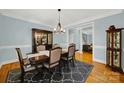 Formal dining room with dark wood table and chairs at 10811 Old Tayport Pl, Charlotte, NC 28277