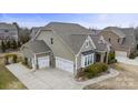 An exterior view reveals a three car garage and tasteful design at 11223 Wescott Hill Dr, Huntersville, NC 28078
