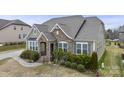 A charming exterior view of a home showcases its inviting entrance and lush front yard landscaping at 11223 Wescott Hill Dr, Huntersville, NC 28078